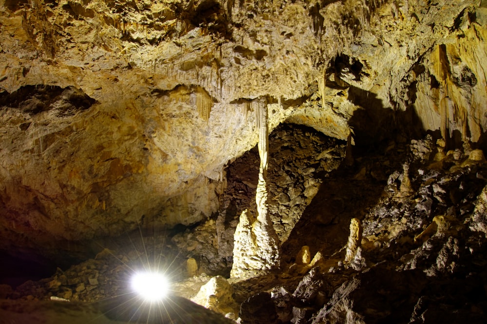 sun rays coming through brown rock formation