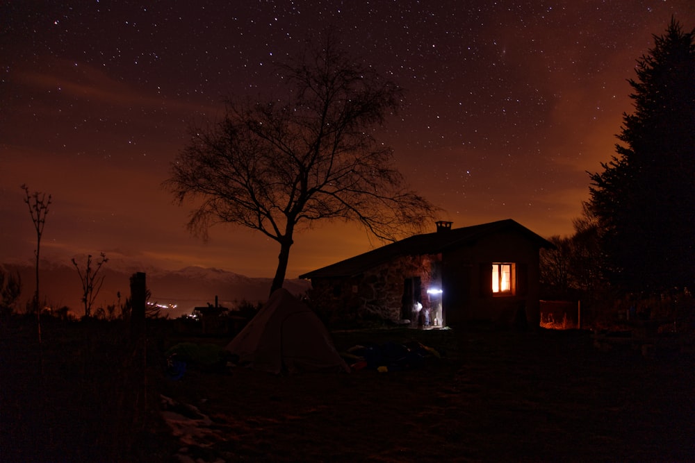 people sitting on camping chairs near bonfire during night time