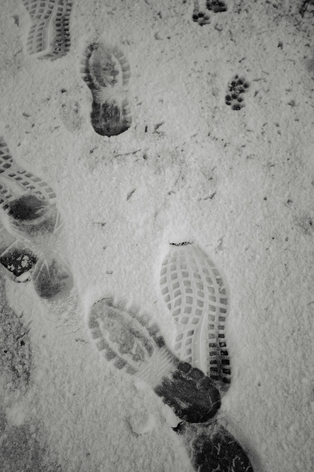 white and black heart drawing on sand