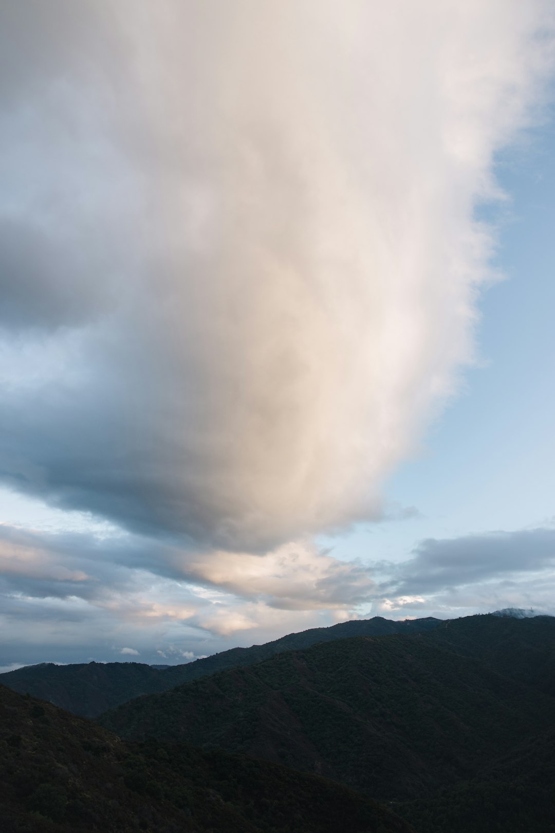 green mountain under white clouds during daytime