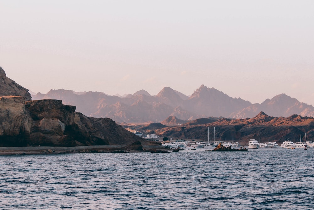 boat on sea near mountain during daytime