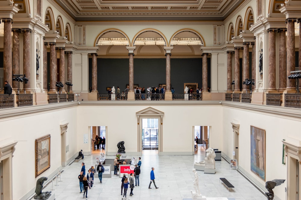 people walking on white concrete building