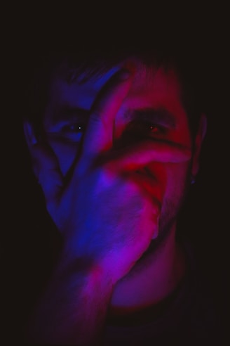 mans face with blue and black color