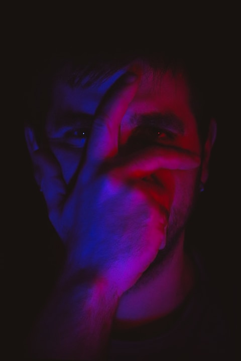 mans face with blue and black color