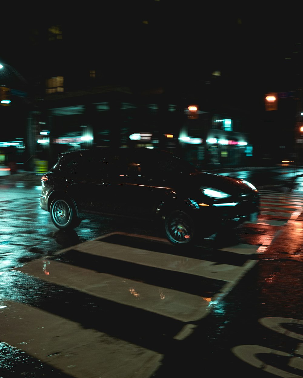 black car on road during night time