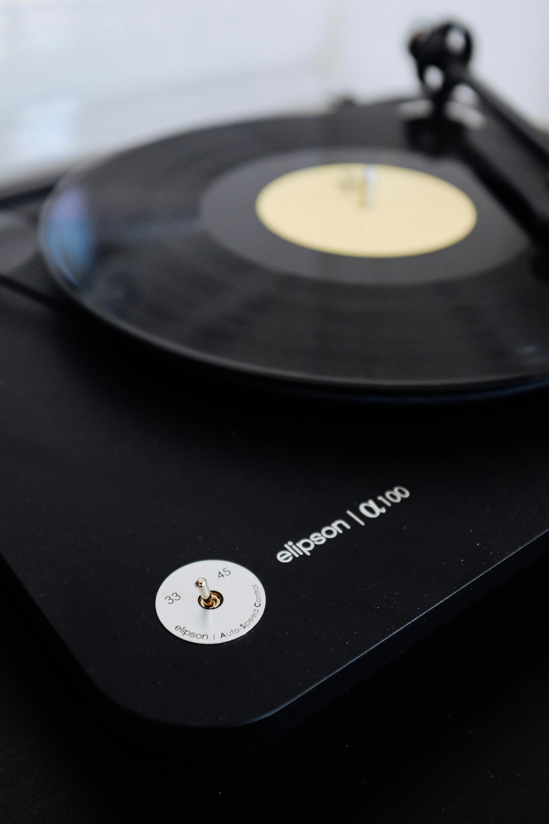 black vinyl record player on black table