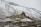 brown concrete houses near snow covered mountain during daytime