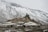 brown concrete houses near snow covered mountain during daytime