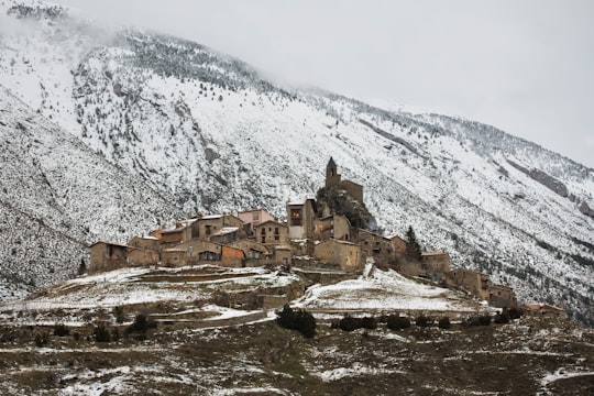 brown concrete houses near snow covered mountain during daytime in Josa de Cadí Spain