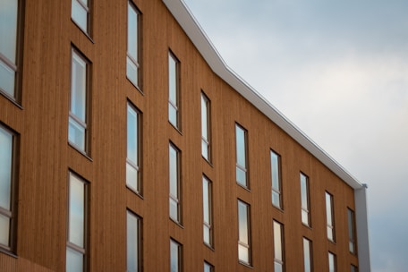 brown concrete building under white clouds during daytime