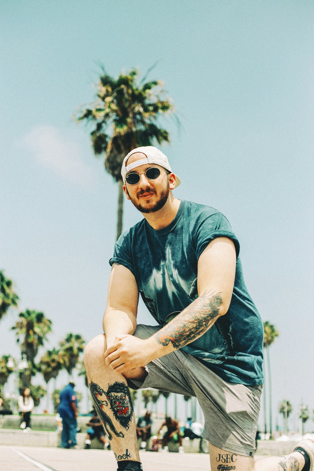 man in blue crew neck t-shirt and blue denim jeans wearing sunglasses