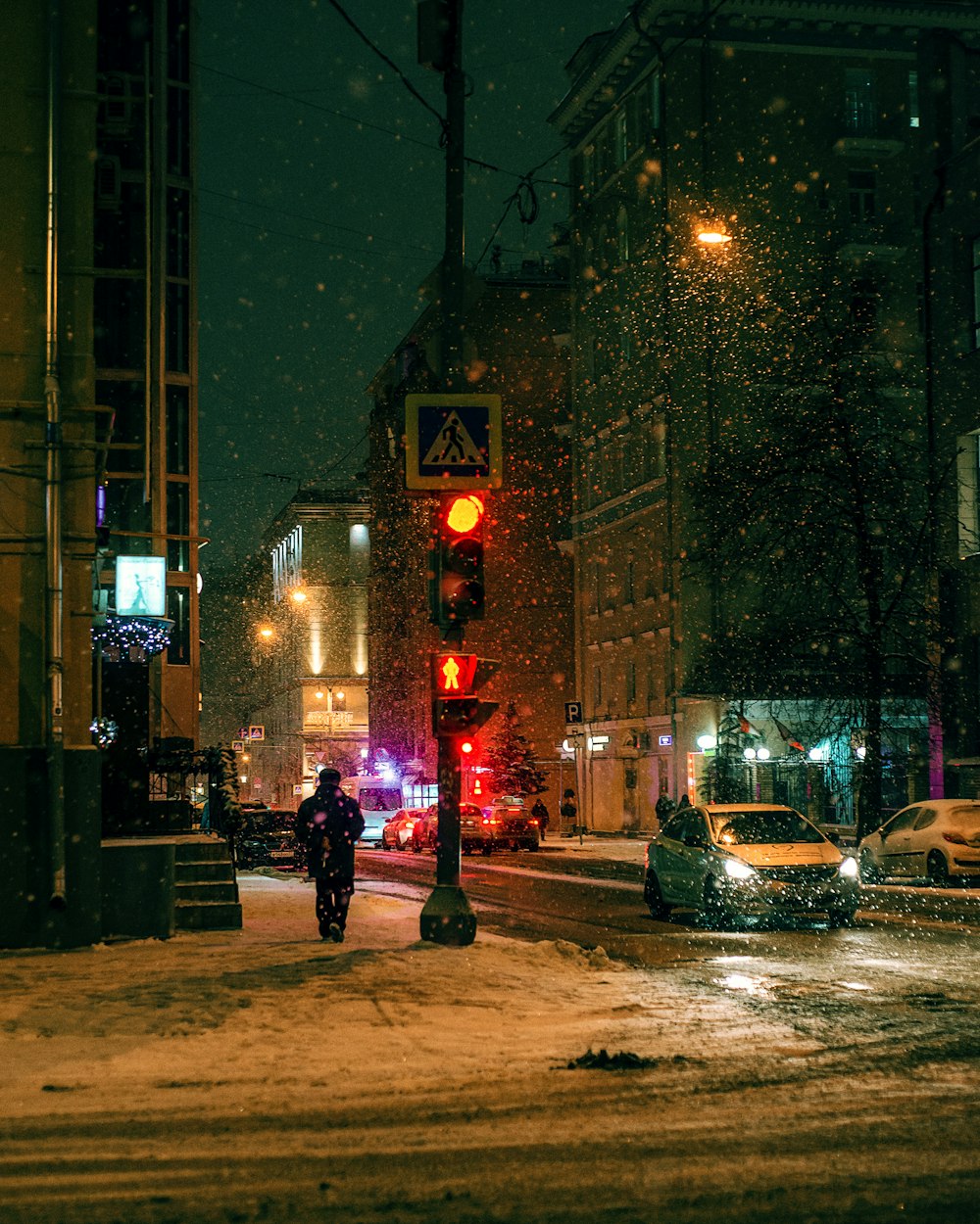 people walking on sidewalk during night time