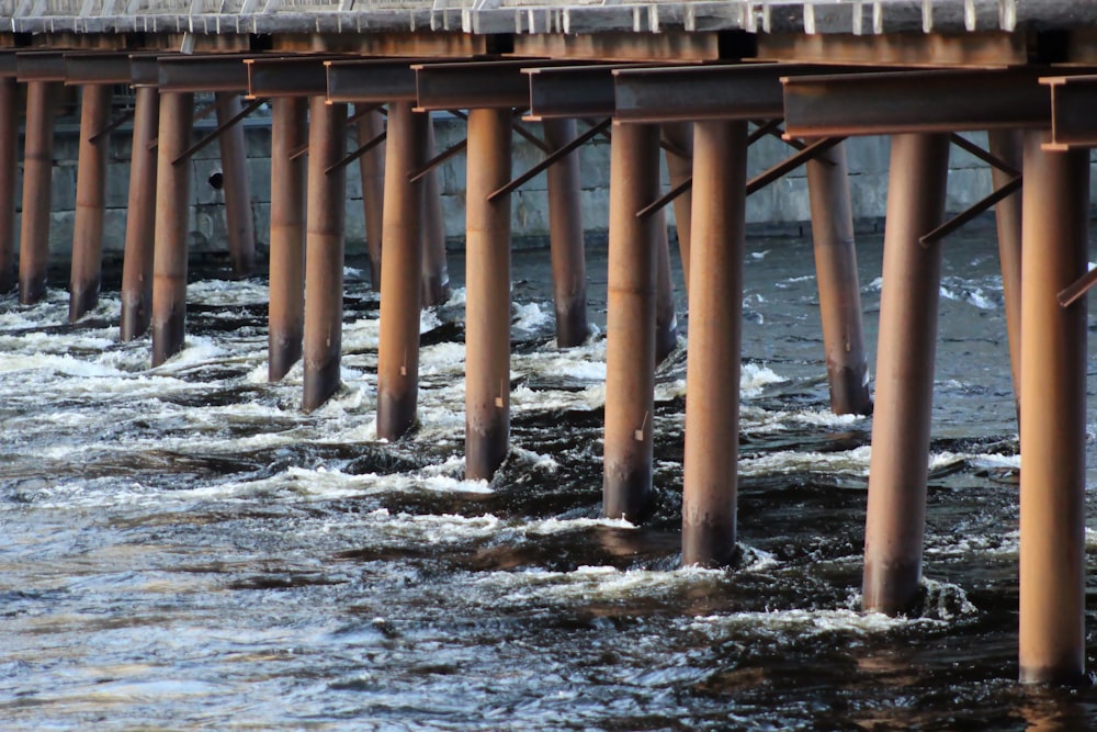 brown wooden dock on body of water during daytime