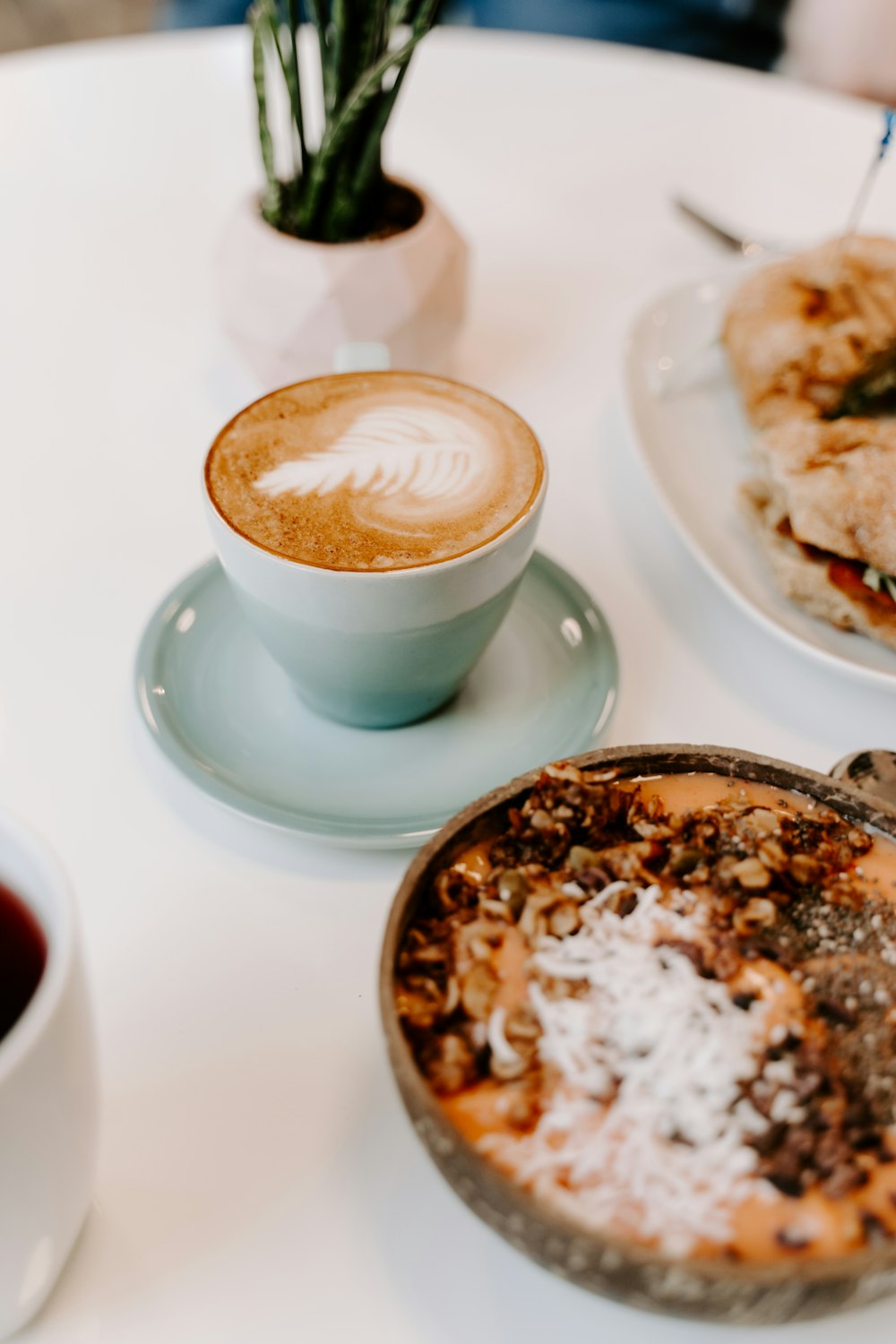 cappuccino in white ceramic cup on white ceramic saucer