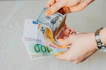person holding 100 euro bill