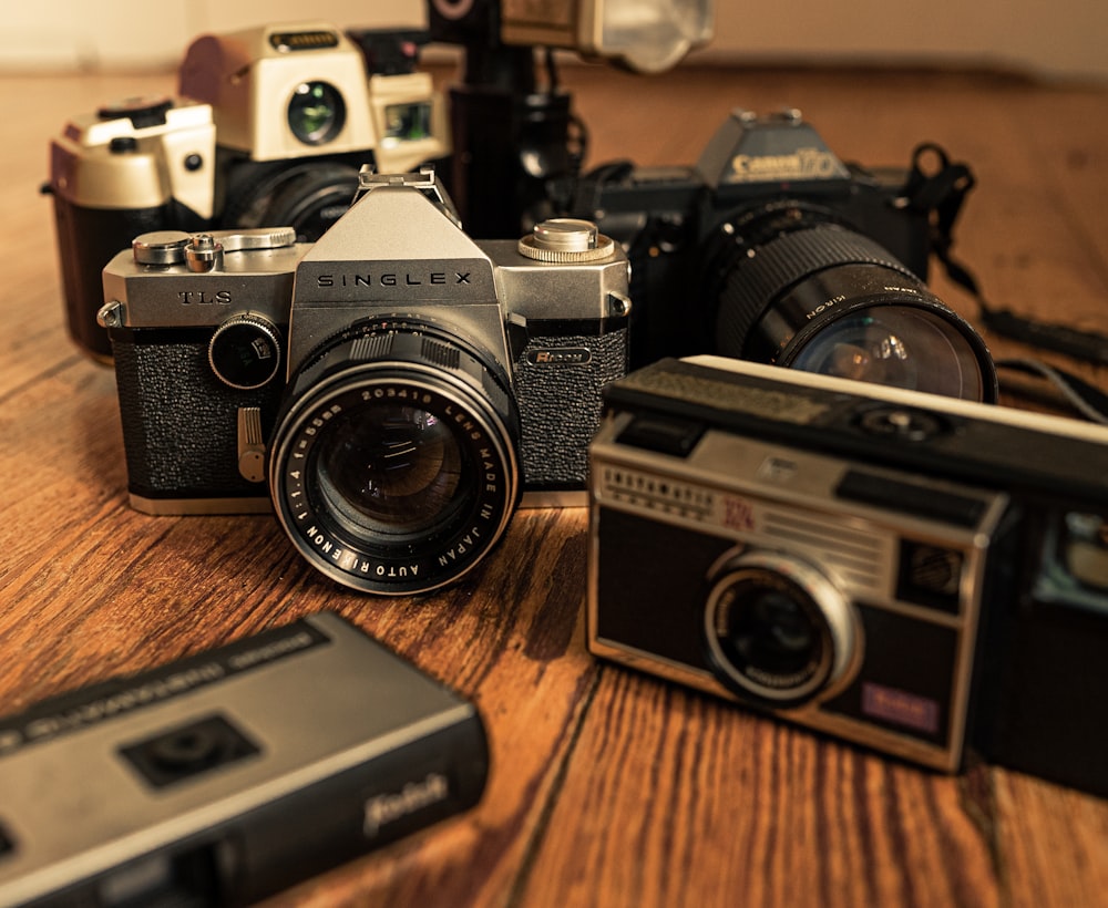 black and silver camera on brown wooden table