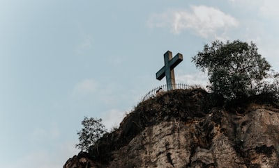 person standing on cliff during daytime hungary teams background