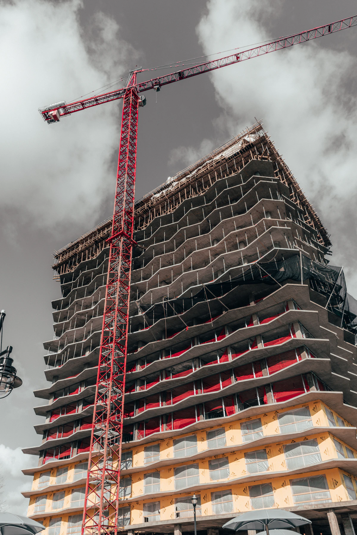 Tower crane beside an unfinished multi-storey concrete building