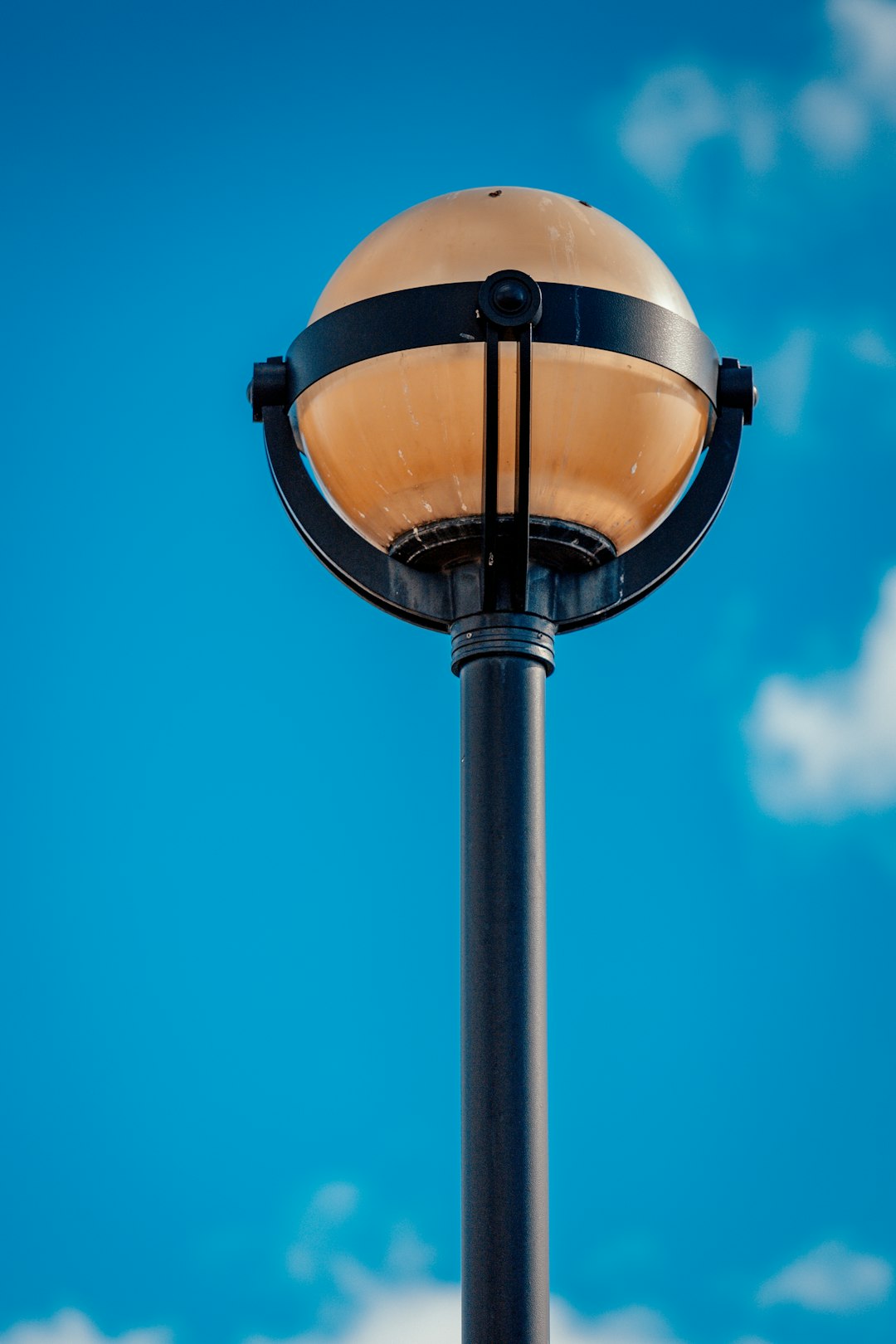 brown and white street lamp under blue sky during daytime