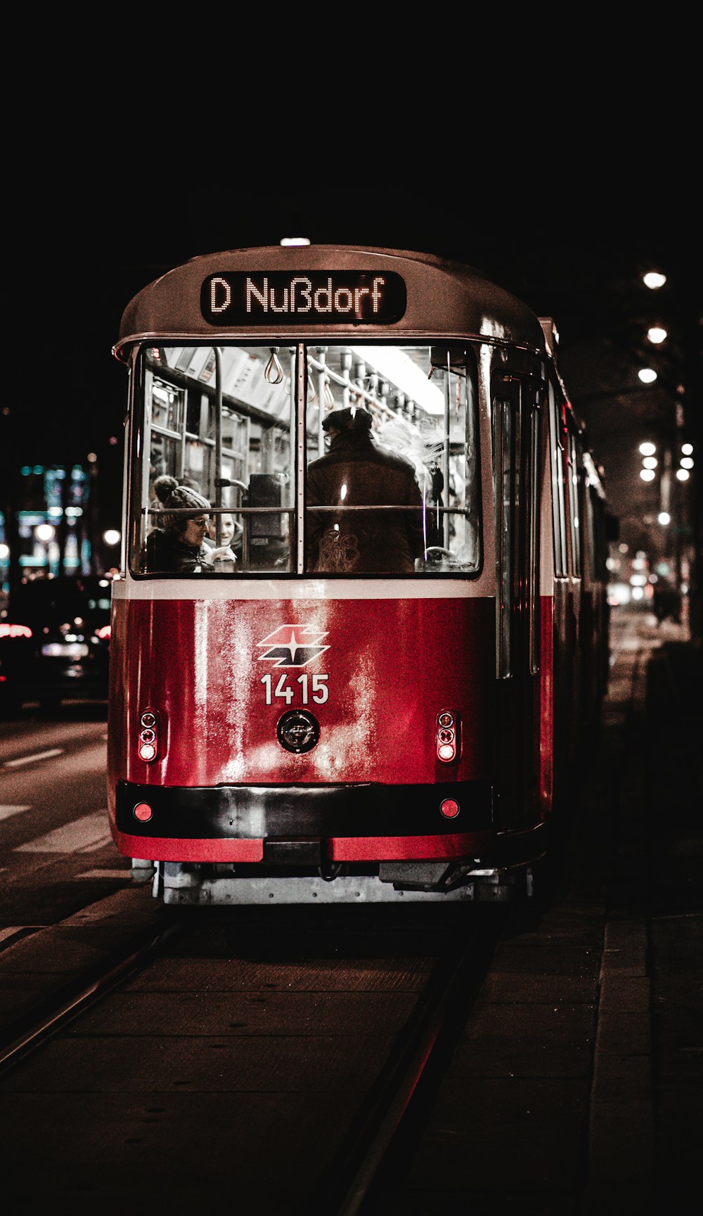 red and white tram on road during daytime