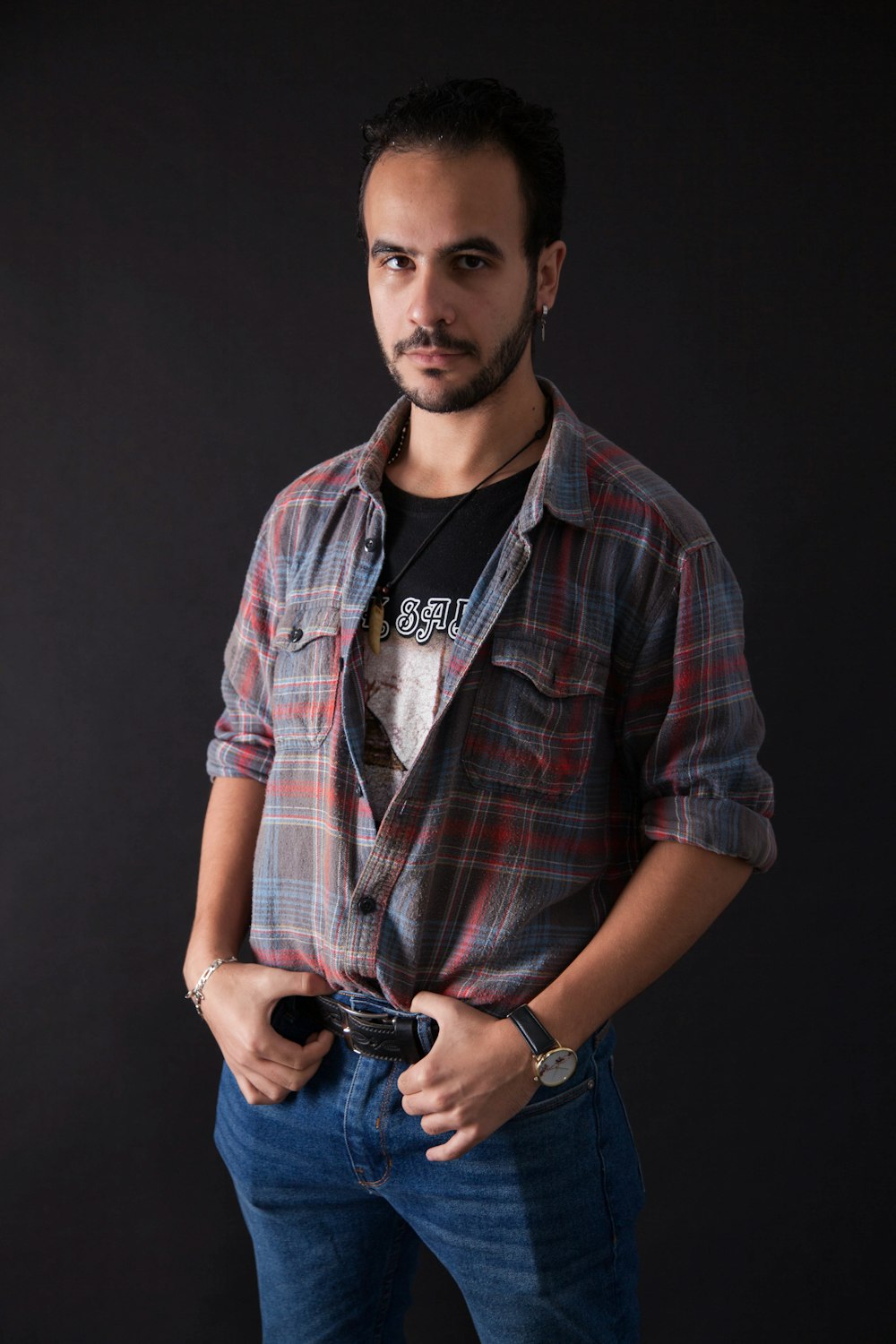 man in blue and red plaid button up shirt holding black dslr camera