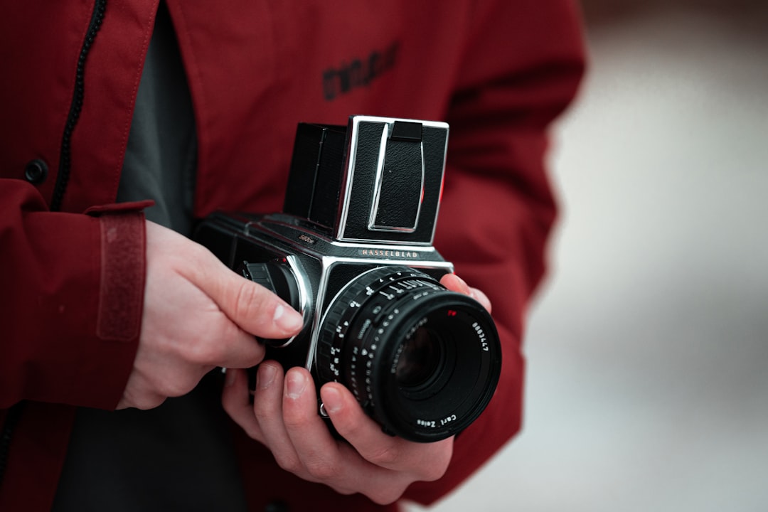 person holding black and silver dslr camera