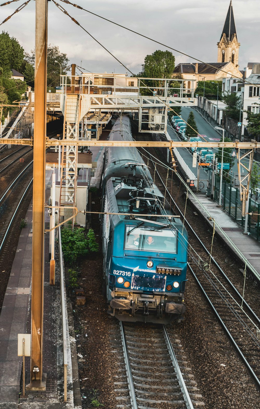 blue and black train on rail tracks during daytime