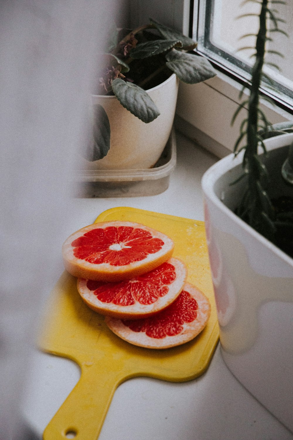 a couple of grapefruits sitting on top of a cutting board