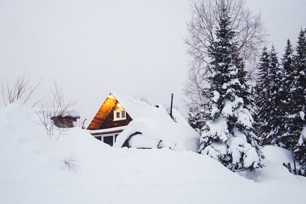 a cabin in the middle of a pile of snow