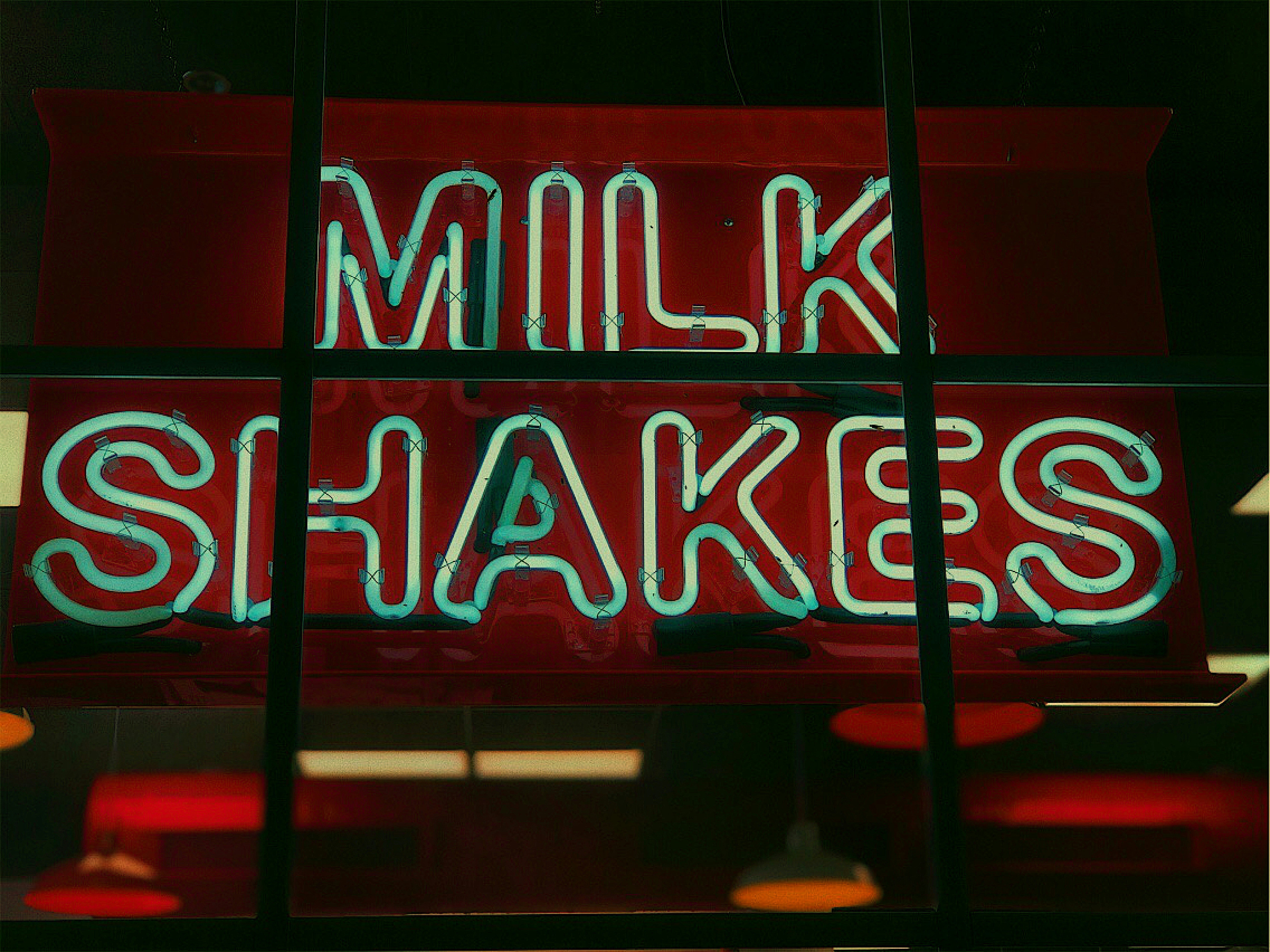 red and white UNKs neon light signage