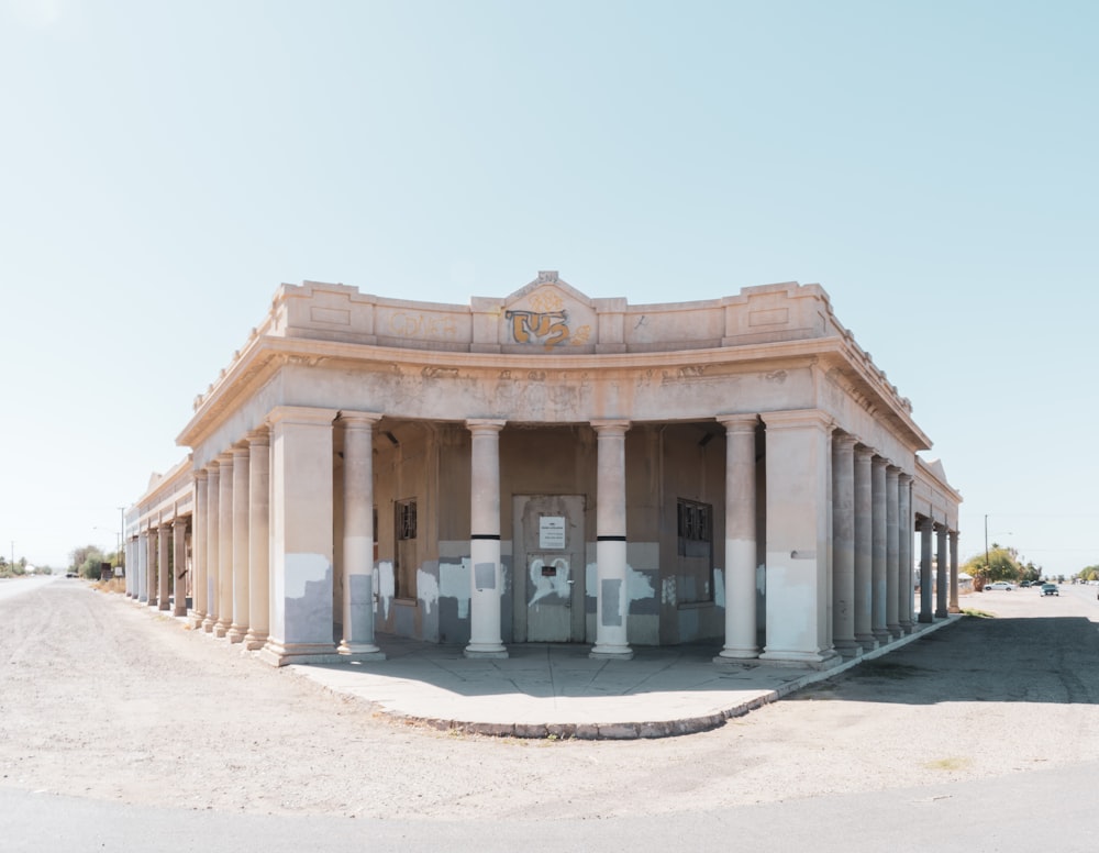 a building with columns and a clock on the top of it