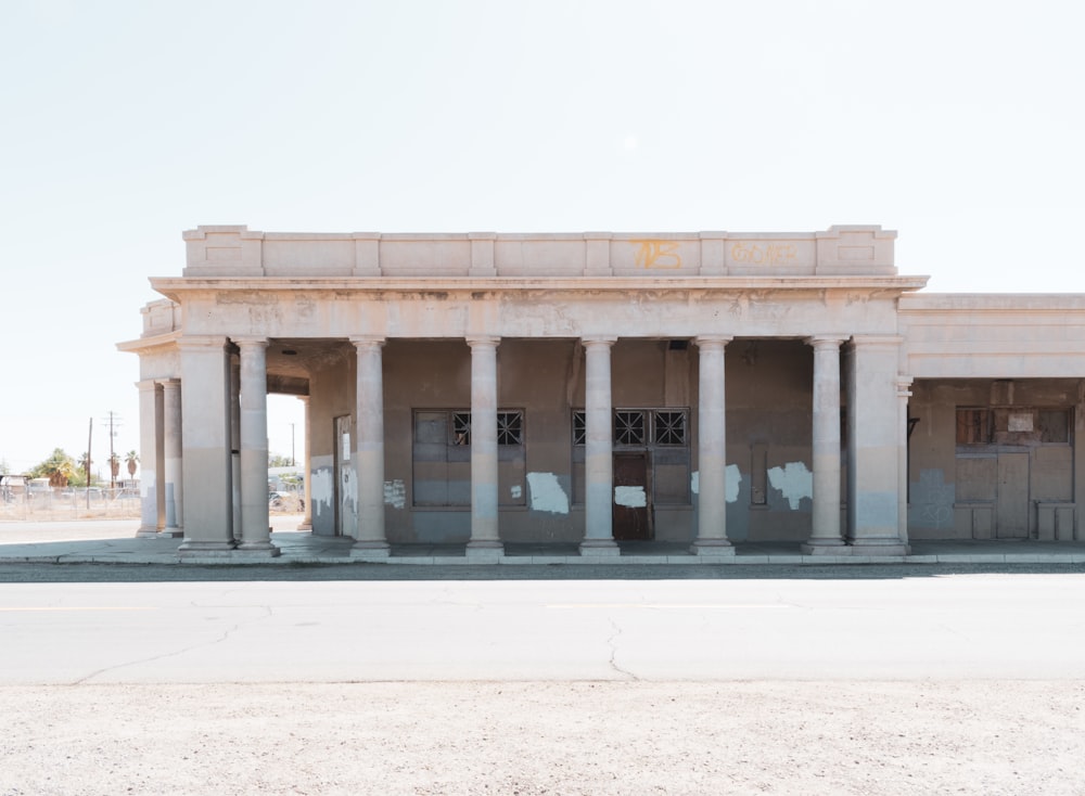 an old building with columns and pillars in front of it