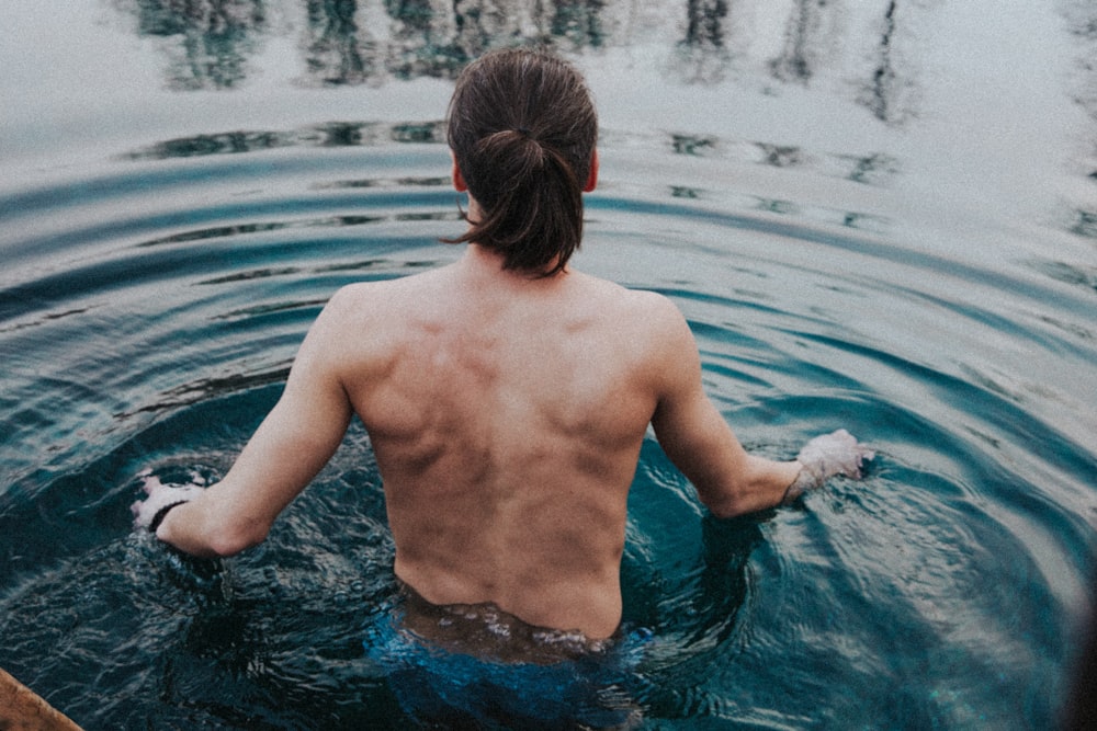 topless woman in water during daytime