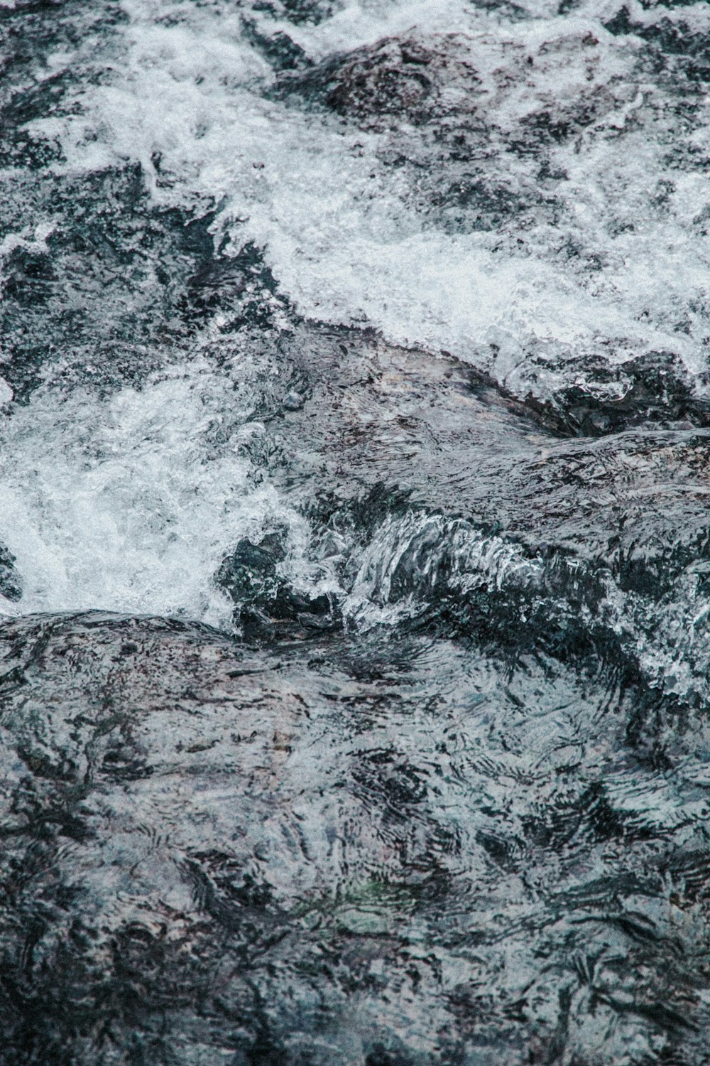 water waves hitting black rock