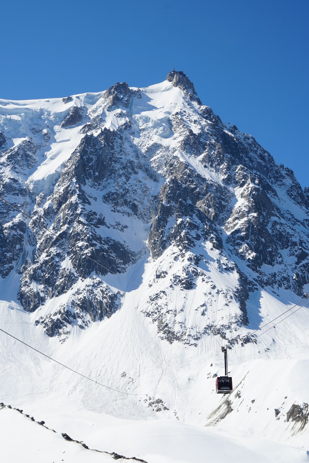 person standing on snow covered mountain during daytime