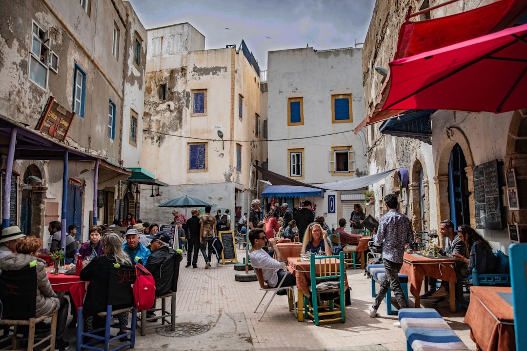 people sitting on chairs near building during daytime