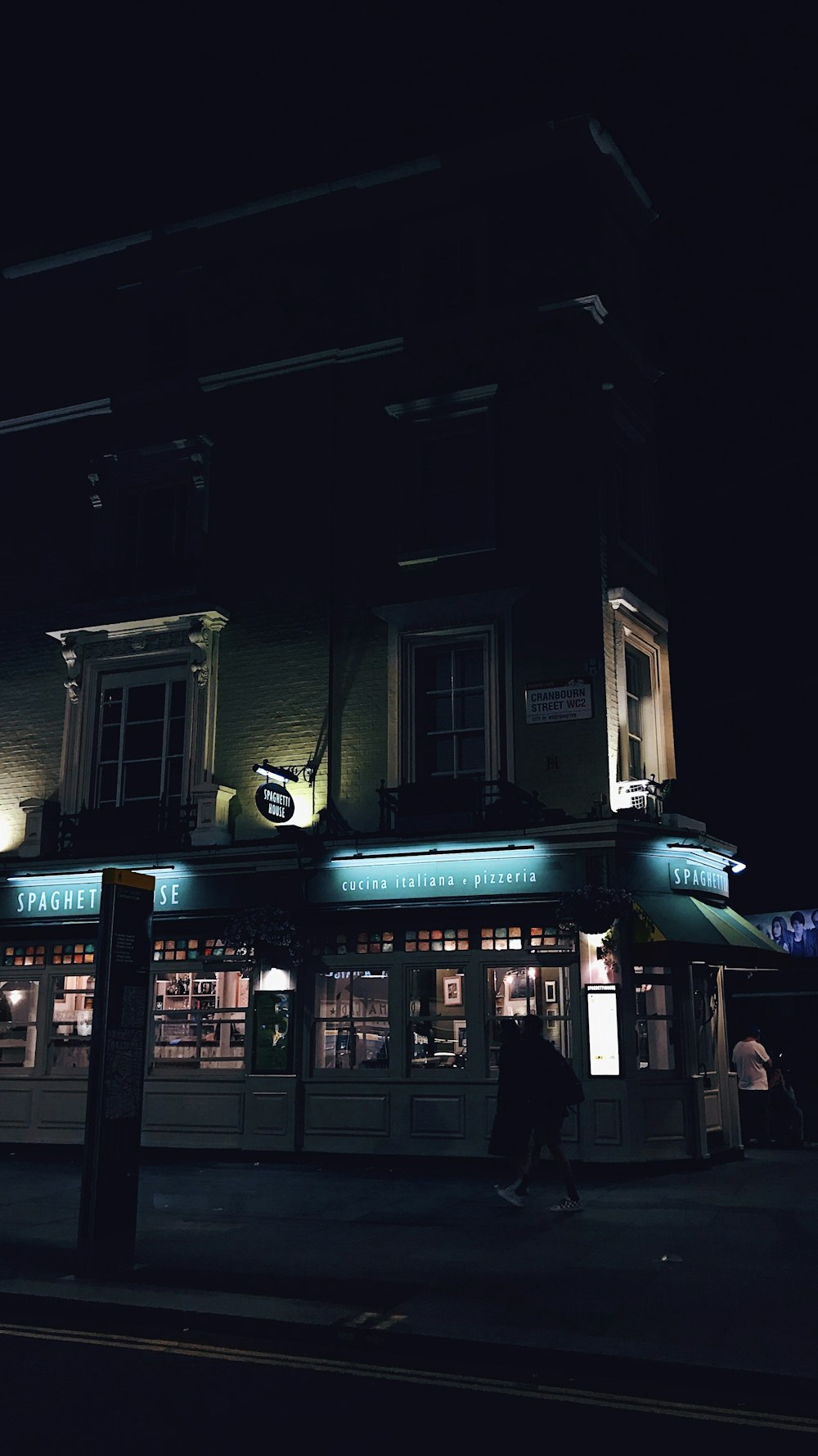 people walking in front of store during night time