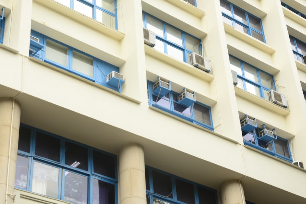 white concrete building with blue windows