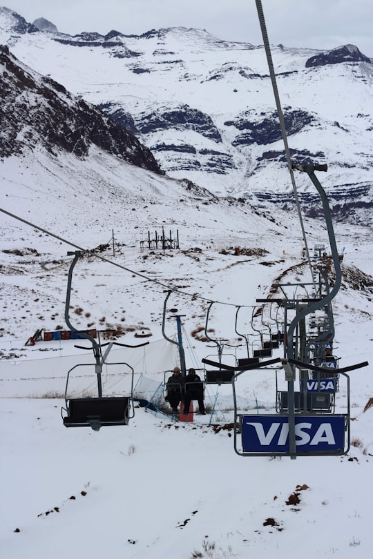 cable cars over snow covered mountain during daytime in Farellones Chile