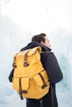 man in black jacket and brown backpack