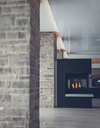 A modern living room featuring elegant natural stone finishes with warm lighting.