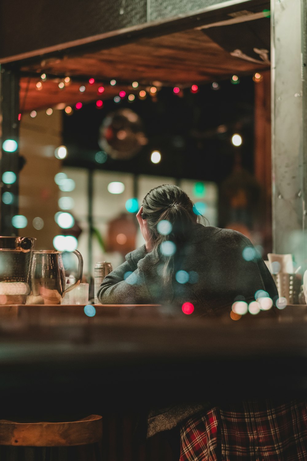 woman in black jacket sitting on chair