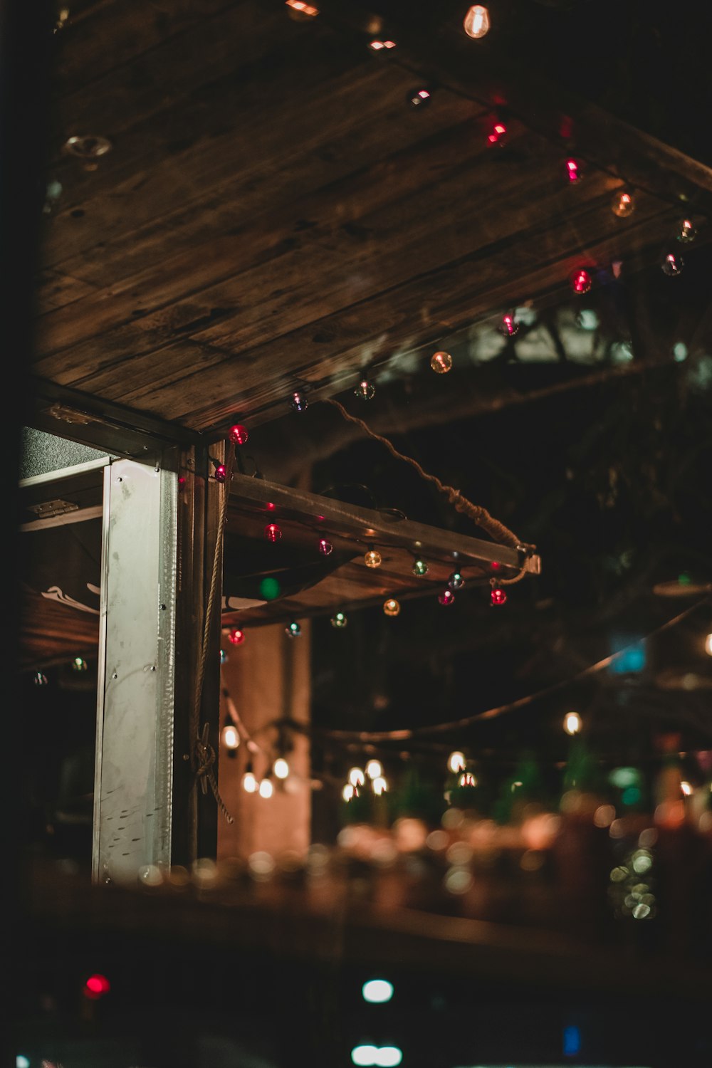 string lights on brown wooden wall