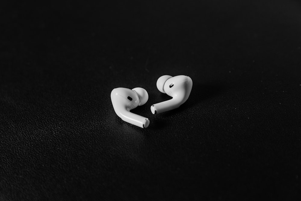 a pair of ear buds sitting on top of a table