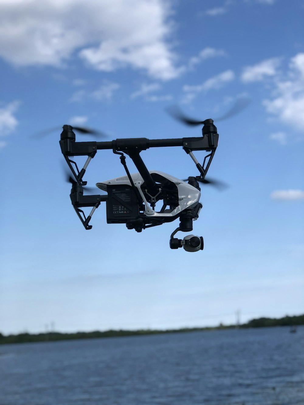 black drone flying during daytime