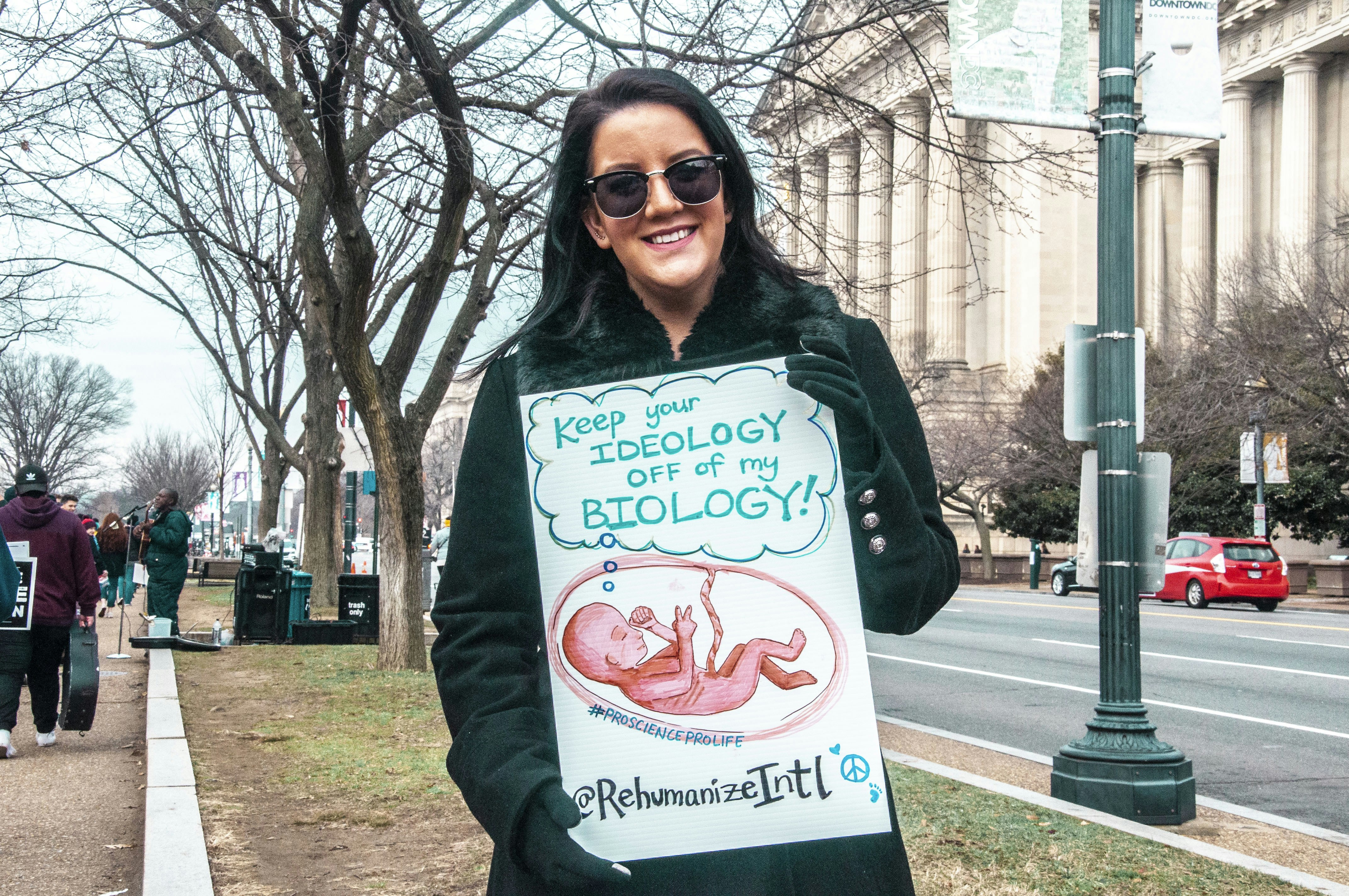 woman in black jacket wearing black frame eyeglasses