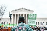 A peaceful rally advocating for human rights with diverse participants holding signs.