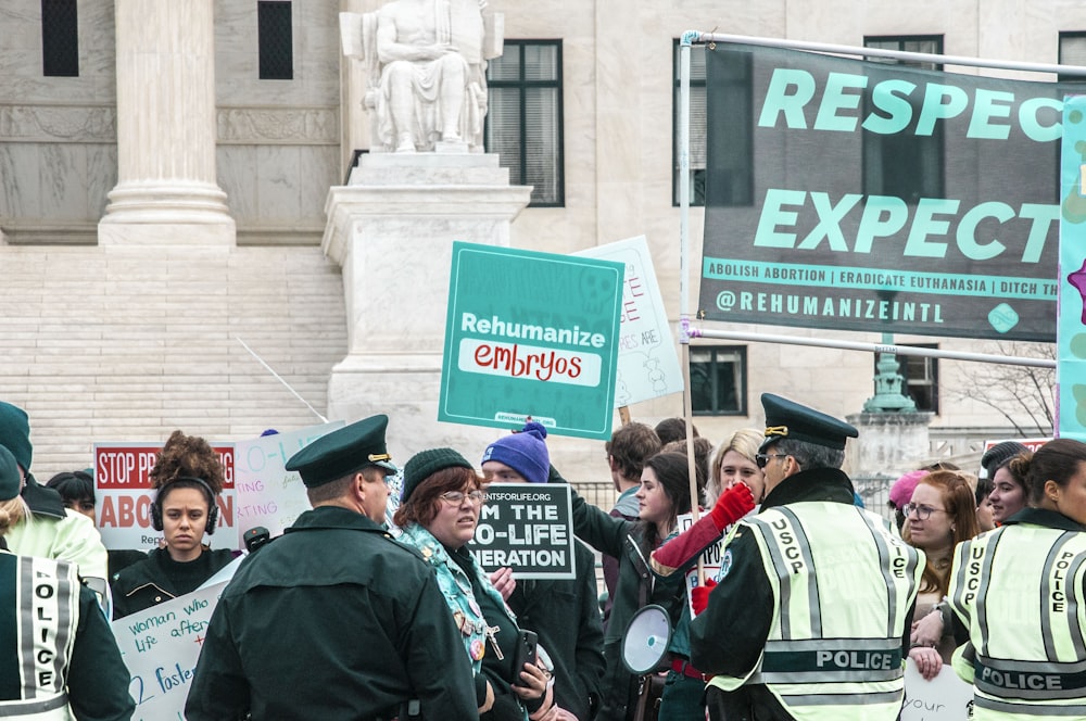 people in green uniform standing near building during daytime