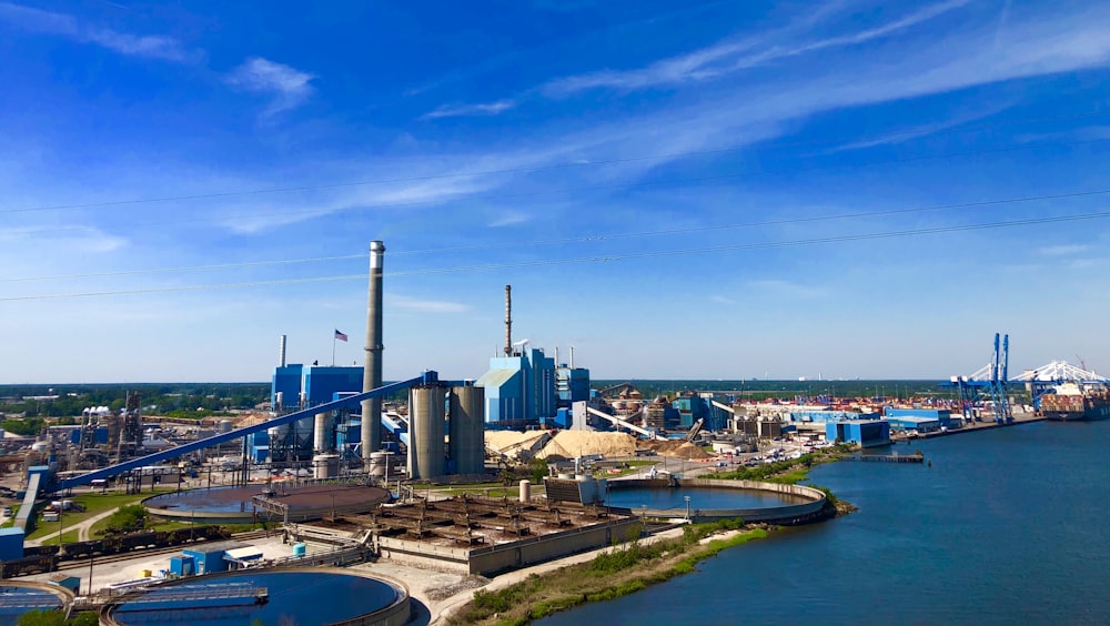 a large industrial plant next to a body of water