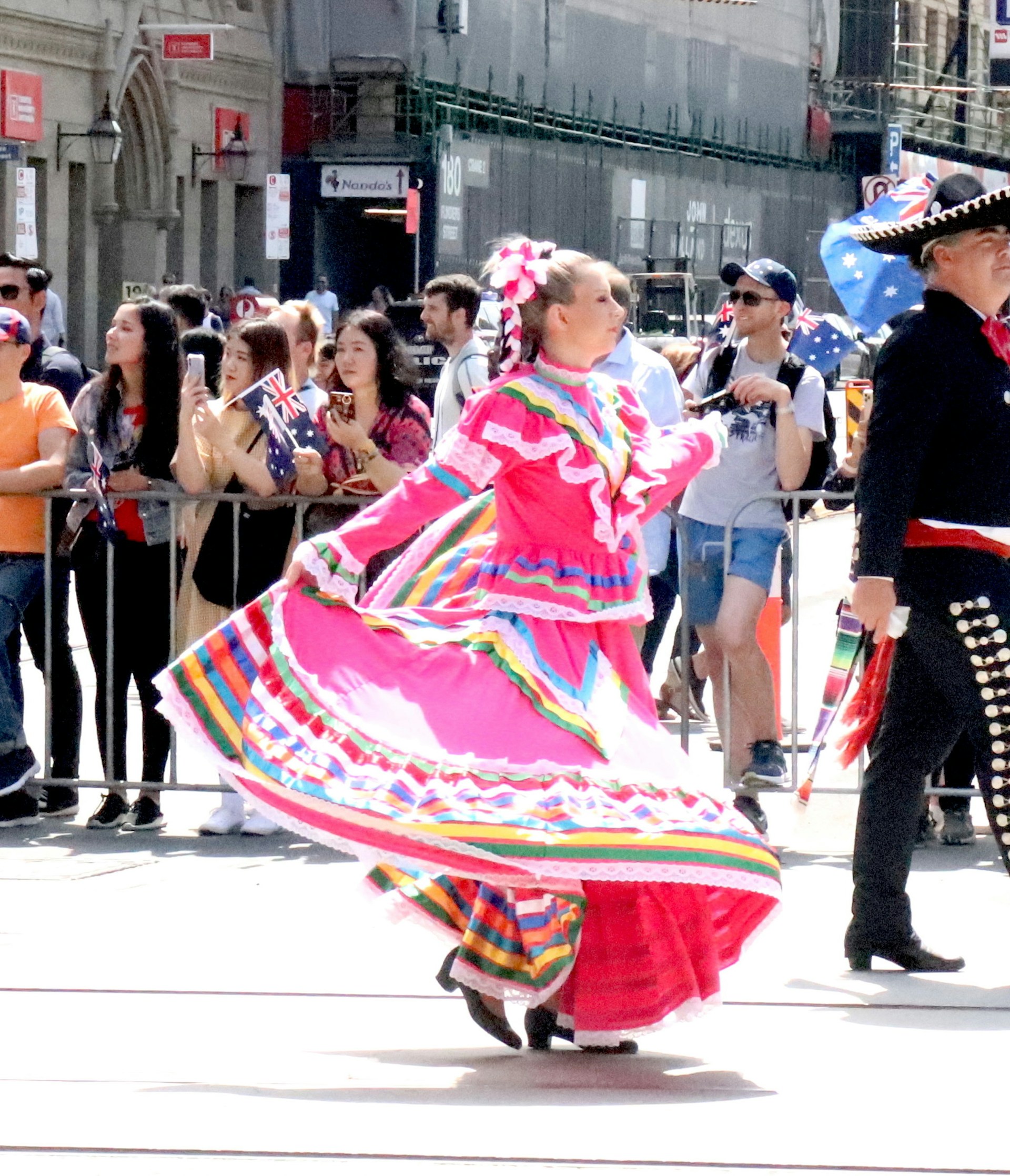 A vibrant scene of a Ukrainian girl in traditional attire dancing joyfully at a cultural festival.